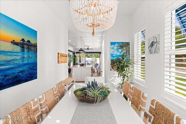 hallway with a notable chandelier, recessed lighting, and a sink