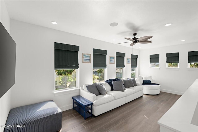 living area featuring a ceiling fan, recessed lighting, wood finished floors, and baseboards