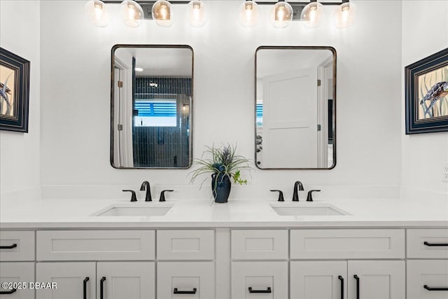 bathroom featuring a sink and double vanity