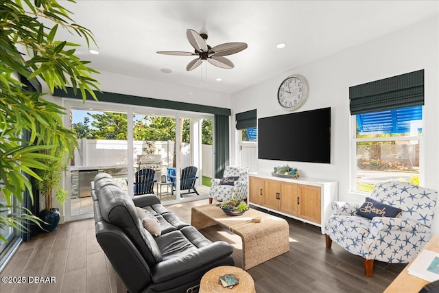 living room featuring dark hardwood / wood-style flooring and ceiling fan