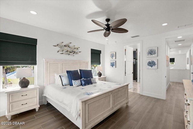 bedroom featuring multiple windows, dark wood-type flooring, and ceiling fan