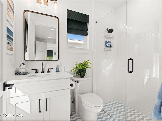 full bath featuring toilet, a stall shower, and vanity