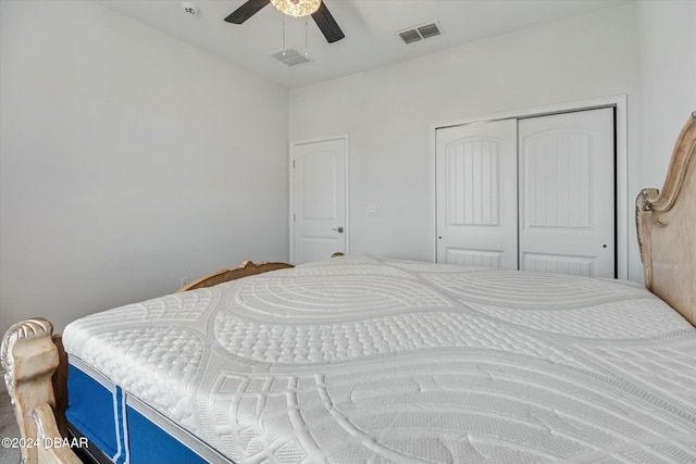 bedroom with ceiling fan and a closet