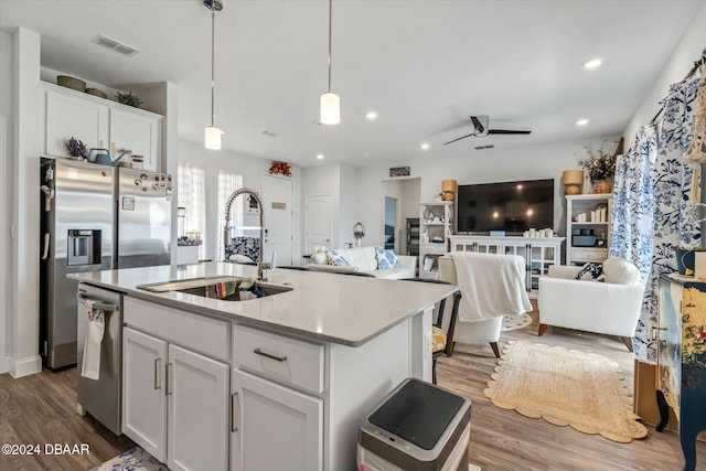 kitchen with ceiling fan, sink, white cabinets, and appliances with stainless steel finishes
