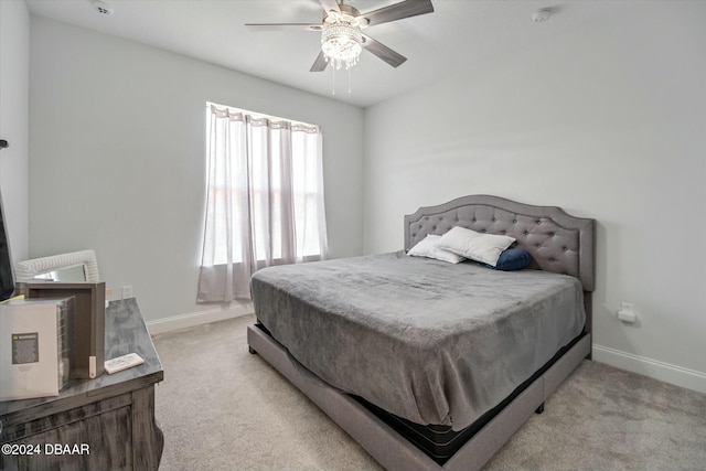 bedroom with ceiling fan and light colored carpet
