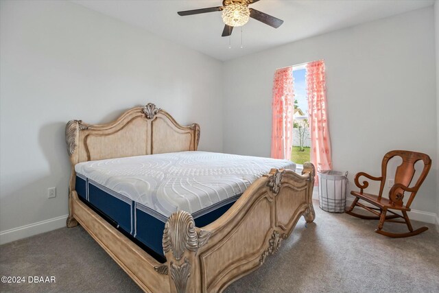 bedroom featuring dark carpet and ceiling fan