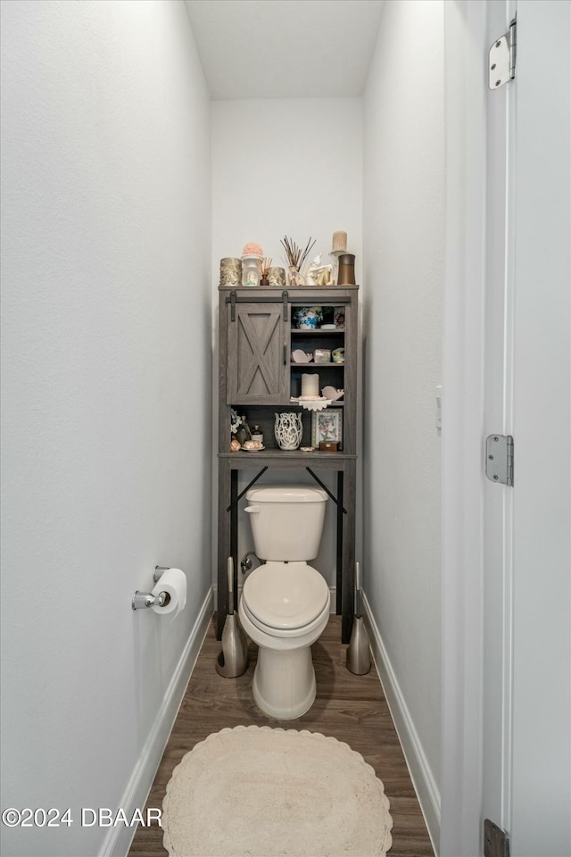 bathroom featuring hardwood / wood-style floors and toilet