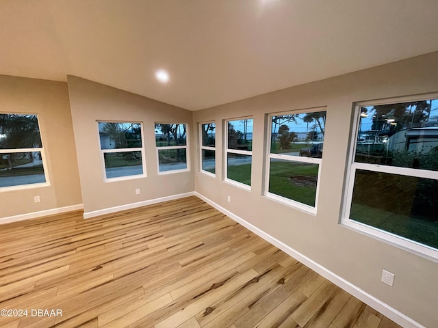 unfurnished sunroom with lofted ceiling