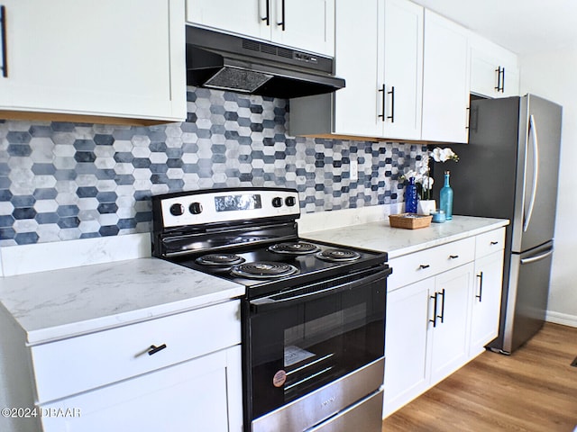 kitchen featuring light stone countertops, stainless steel appliances, white cabinetry, and light hardwood / wood-style floors