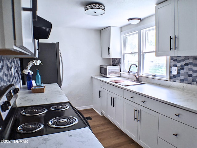 kitchen with electric range, sink, white cabinets, and dark wood-type flooring