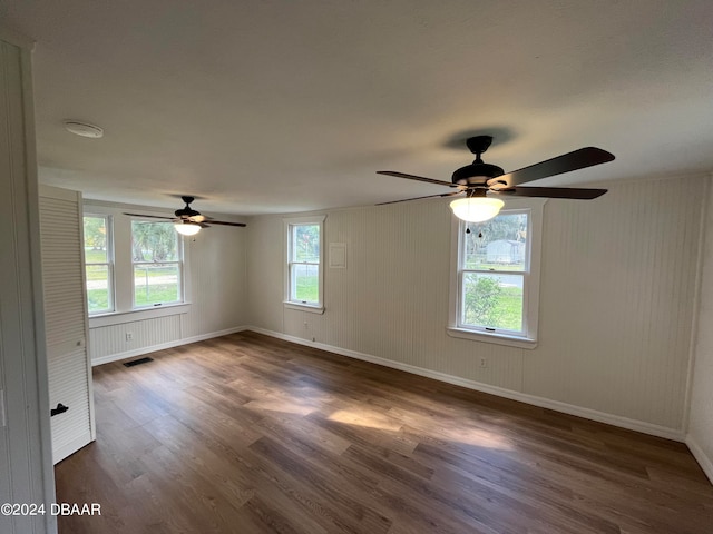 spare room featuring dark hardwood / wood-style flooring and ceiling fan