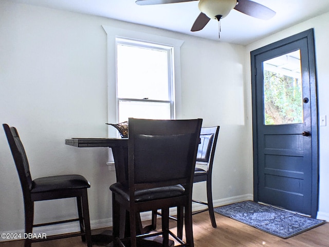 dining room with hardwood / wood-style flooring and ceiling fan