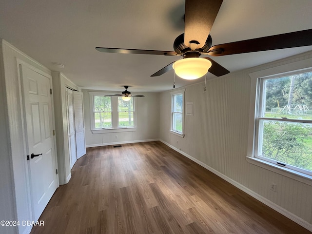 spare room featuring hardwood / wood-style floors, a wealth of natural light, and ceiling fan