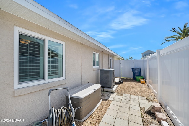 view of side of property featuring central AC and a patio area