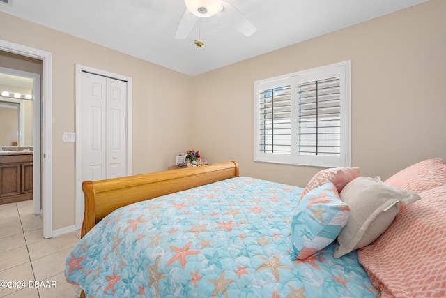 tiled bedroom featuring ceiling fan and a closet