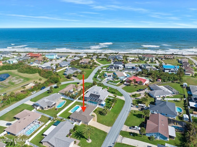 aerial view with a water view and a view of the beach