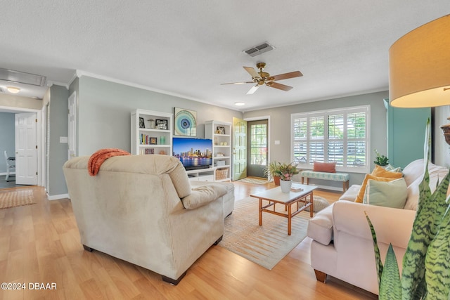 living room with crown molding, ceiling fan, a textured ceiling, and light hardwood / wood-style flooring