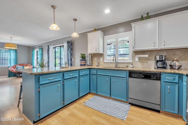 kitchen featuring pendant lighting, sink, stainless steel dishwasher, and white cabinets