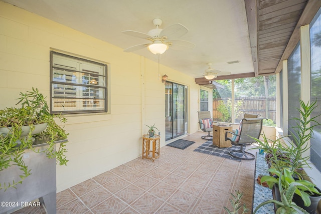 sunroom / solarium featuring ceiling fan