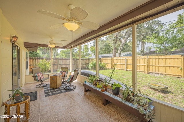 sunroom featuring ceiling fan