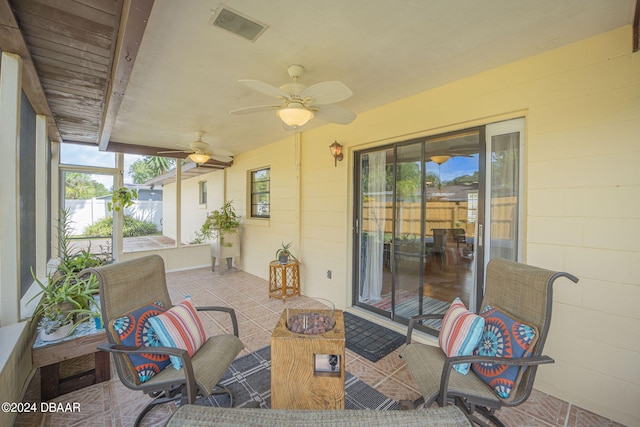 sunroom featuring ceiling fan