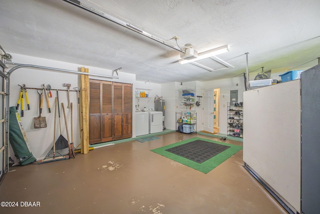 garage with a garage door opener and washer and dryer