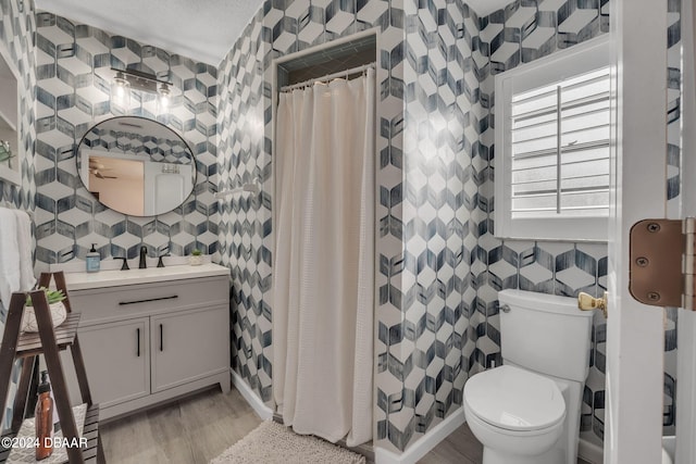 bathroom featuring vanity, curtained shower, toilet, and hardwood / wood-style flooring