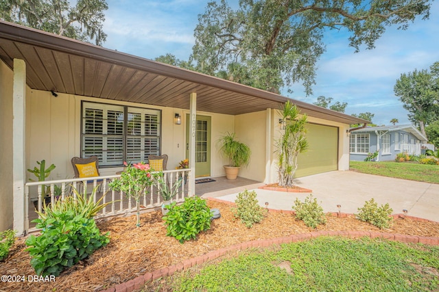 ranch-style home featuring a porch and a garage