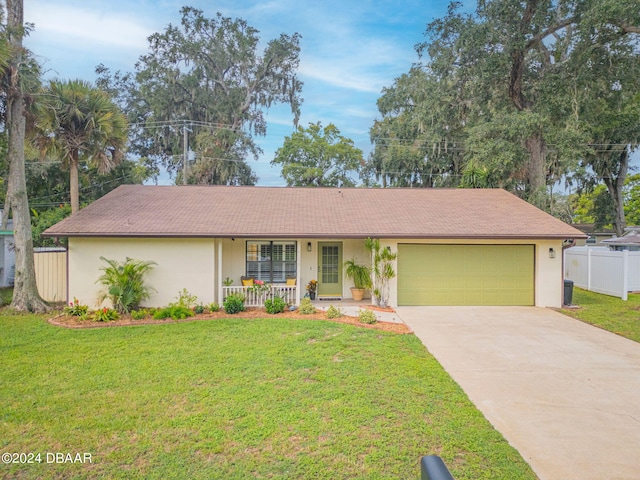 single story home with a garage, a front yard, and covered porch