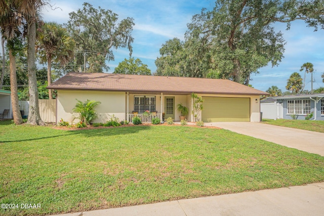 ranch-style home featuring a garage, a front yard, and a porch