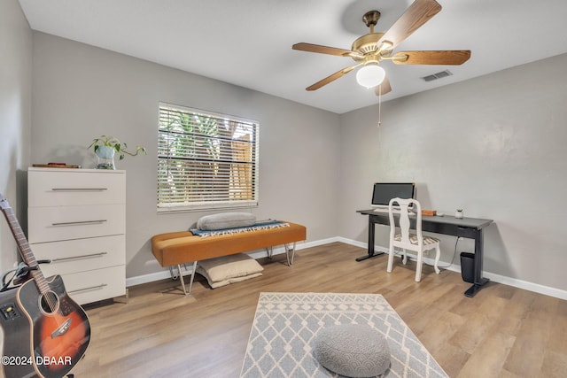 home office with ceiling fan and light hardwood / wood-style flooring