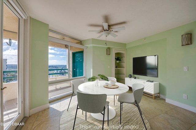 dining area with ceiling fan and light tile patterned flooring