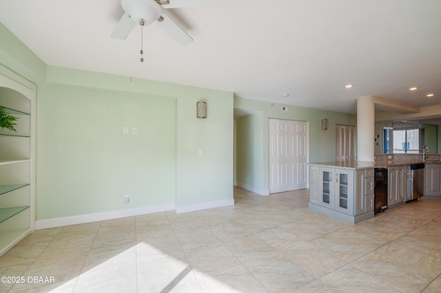 interior space with ceiling fan, built in features, and sink