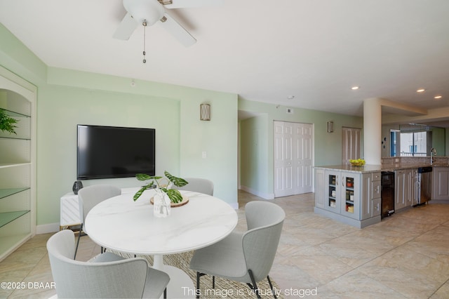 dining space featuring ceiling fan and sink