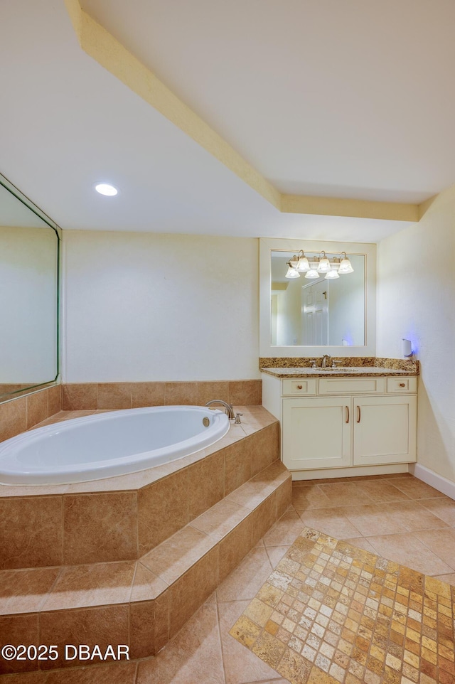 bathroom featuring vanity, tile patterned floors, and a relaxing tiled tub