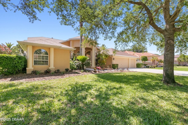 view of front of property with stucco siding, a front lawn, concrete driveway, and an attached garage