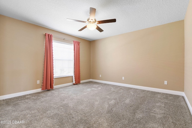 carpeted empty room featuring baseboards, a textured ceiling, and ceiling fan