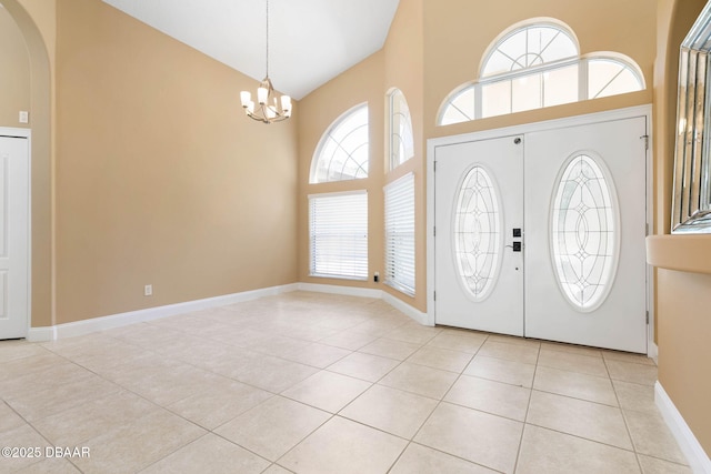 foyer featuring light tile patterned floors, arched walkways, high vaulted ceiling, and an inviting chandelier