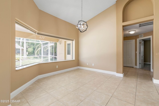 unfurnished room with tile patterned flooring, visible vents, an inviting chandelier, and baseboards