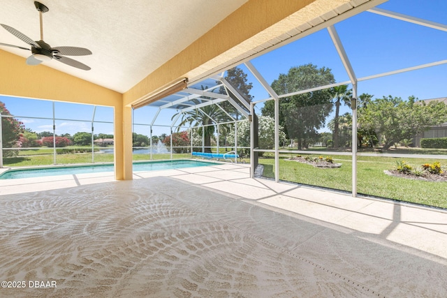 outdoor pool featuring a patio area, a yard, a lanai, and a ceiling fan