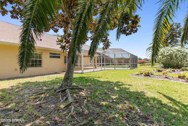 view of yard featuring glass enclosure and an outdoor pool