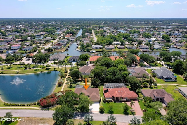 drone / aerial view featuring a residential view and a water view