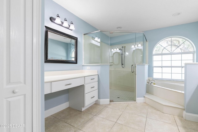 bathroom with vanity, baseboards, a stall shower, tile patterned flooring, and a garden tub