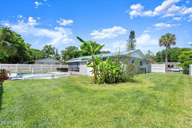 view of yard with a sunroom, a fenced in pool, and a fenced backyard