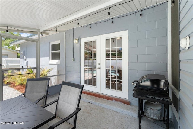 sunroom with outdoor dining area and french doors