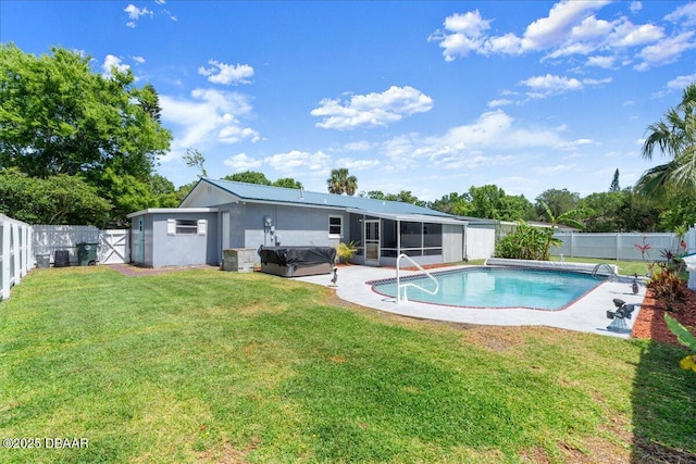 view of pool with a hot tub, a fenced backyard, a fenced in pool, a lawn, and a sunroom