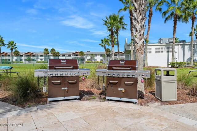 231 Riverside Dr Unit 1903-1, Daytona Beach, FL 32117 - view of patio / terrace featuring area for grilling, a residential view, and fence