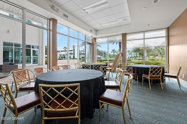 231 Riverside Dr Unit 1903-1, Daytona Beach, FL 32117 - sunroom with healthy amount of natural light, carpet, and a drop ceiling