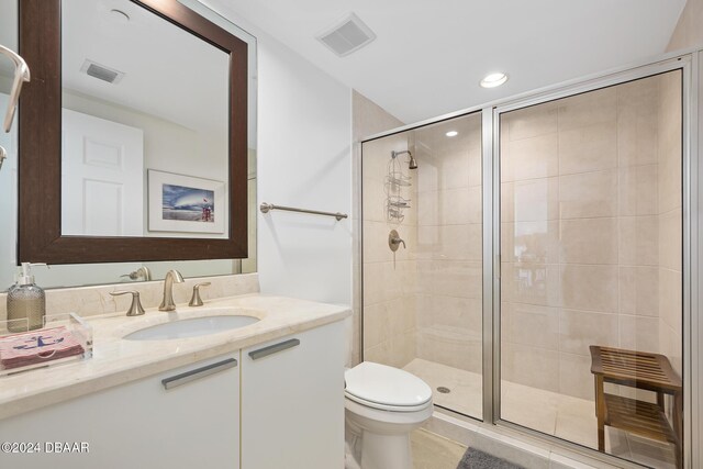 231 Riverside Dr Unit 1903-1, Daytona Beach, FL 32117 - bathroom with a shower stall, toilet, recessed lighting, vanity, and tile patterned floors