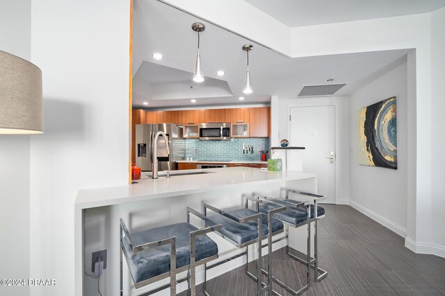 231 Riverside Dr Unit 1903-1, Daytona Beach, FL 32117 - kitchen with brown cabinetry, stainless steel appliances, baseboards, modern cabinets, and recessed lighting